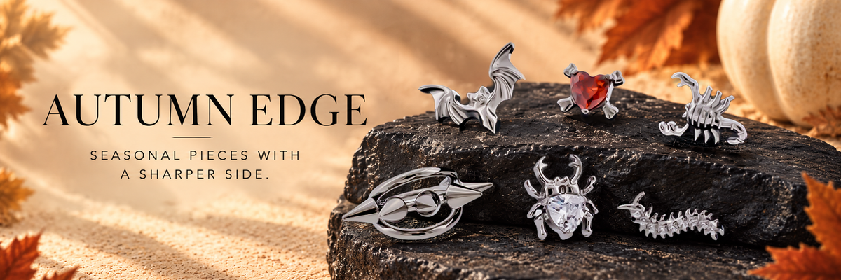 fall themed background with bold and seasonal titanium body jewelry ends on a rock