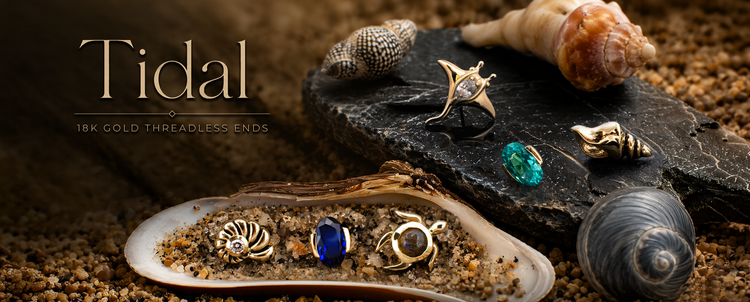 Tidal, 18kt gold luxurious ocean themed body jewelry collection arranged on shells and sand 