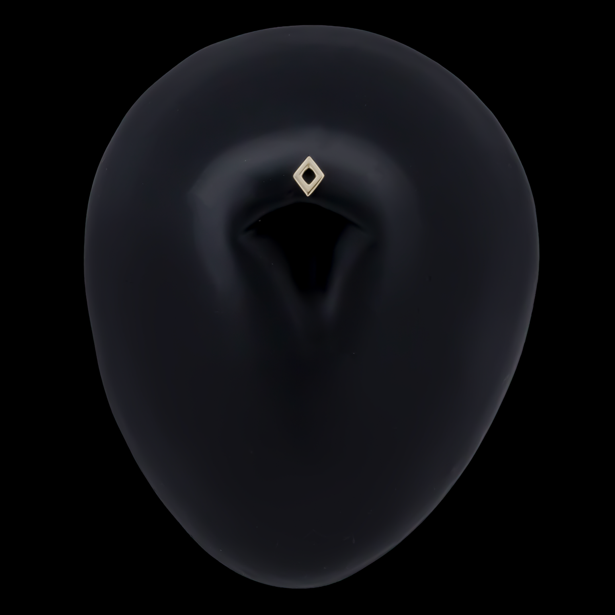 Gold open diamond-shaped end shown in a navel piercing