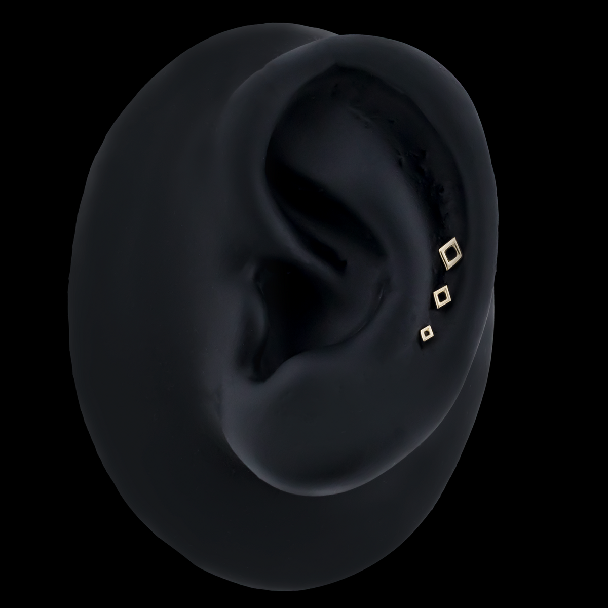 Gold open diamond-shaped end shown in an ear piercing